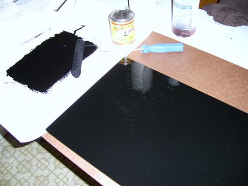 Black oil based paint rolled over the entire surface.
